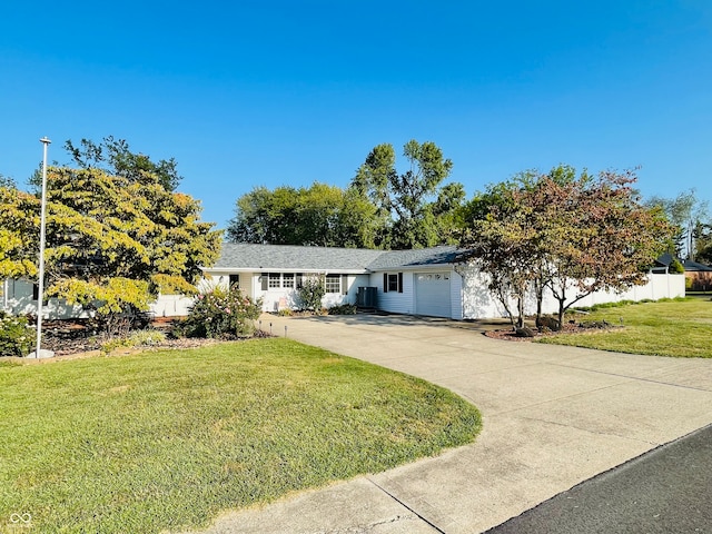 ranch-style home with a front lawn and a garage