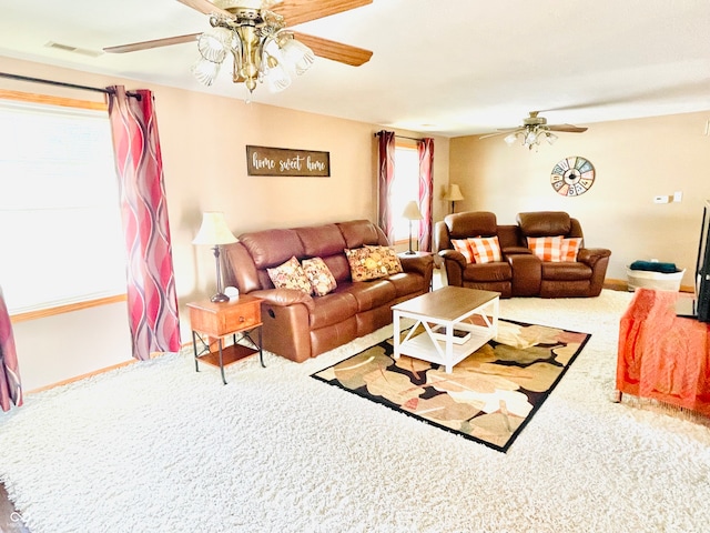 carpeted living room featuring ceiling fan