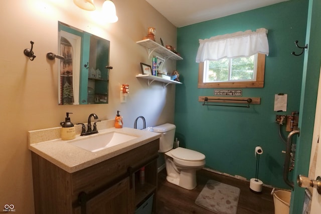 bathroom with hardwood / wood-style floors, vanity, and toilet