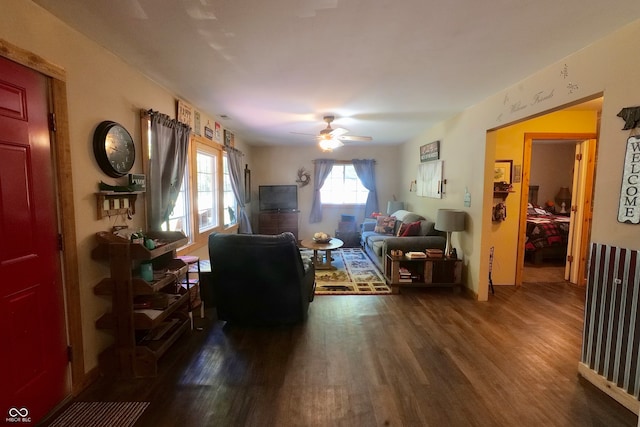 living room with ceiling fan and hardwood / wood-style flooring