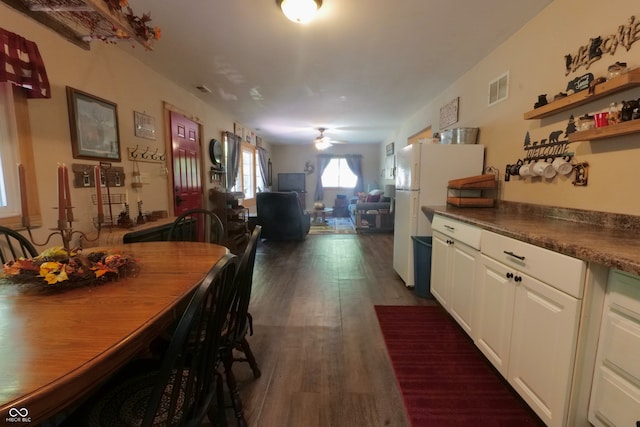 dining room featuring ceiling fan and dark wood-type flooring