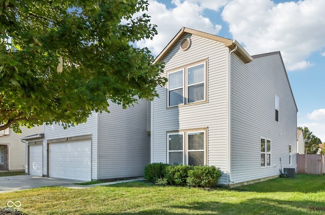 view of front of home with central AC, a front yard, and a garage