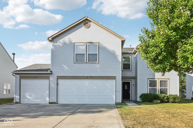 view of property featuring a front lawn and a garage