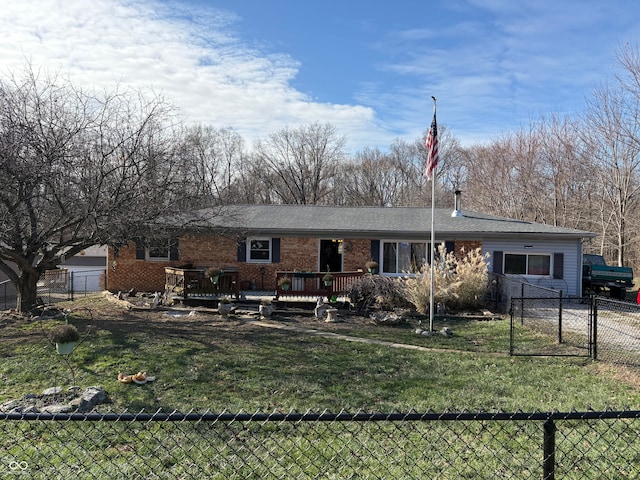 ranch-style house featuring a wooden deck and a front lawn