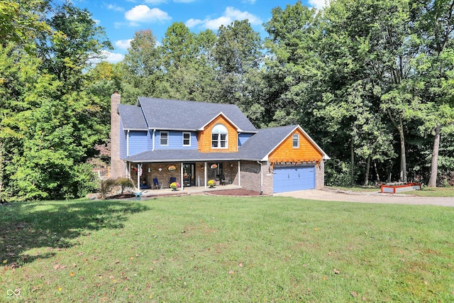 view of front of house with a front yard, a garage, and covered porch