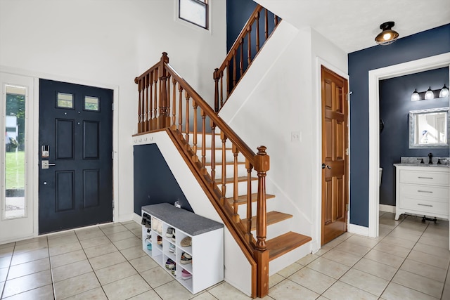 entryway with light tile patterned flooring and sink