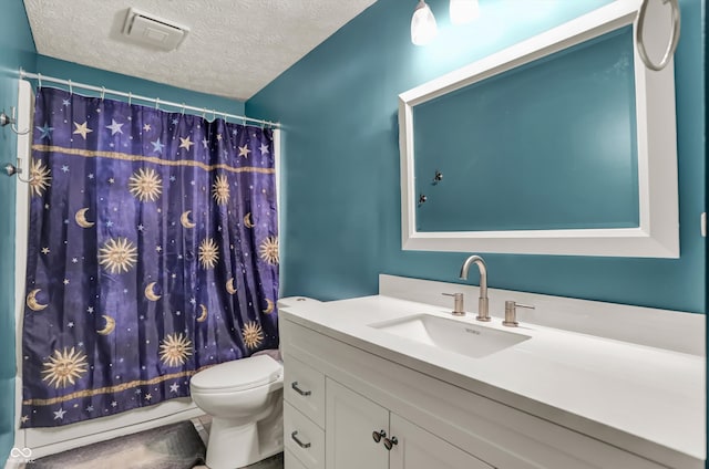 bathroom featuring a textured ceiling, vanity, and toilet