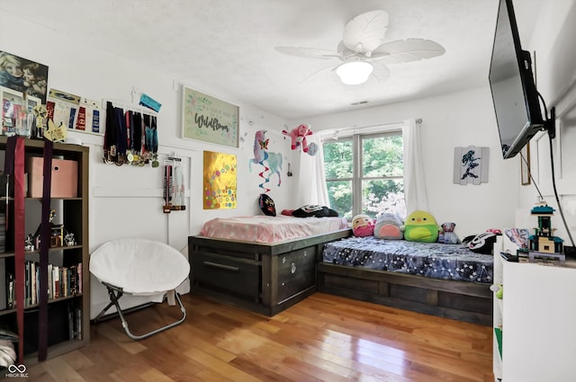 bedroom featuring ceiling fan and light hardwood / wood-style flooring