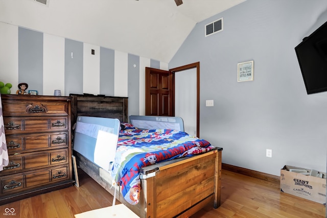 bedroom with ceiling fan, light wood-type flooring, and vaulted ceiling