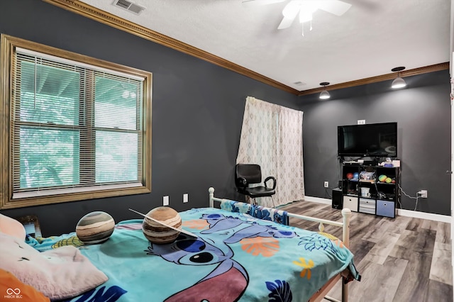 bedroom featuring ornamental molding, hardwood / wood-style floors, and ceiling fan