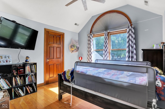 bedroom with ceiling fan, hardwood / wood-style flooring, and lofted ceiling