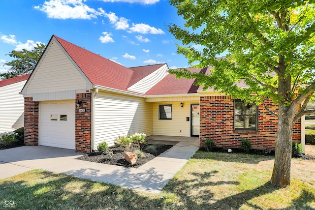 view of front of house with a front yard and a garage