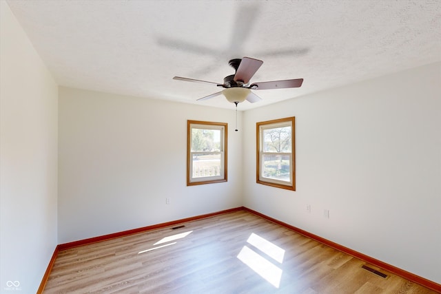 unfurnished room with light hardwood / wood-style flooring, a textured ceiling, and ceiling fan