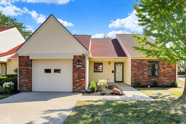 ranch-style home with a front yard and a garage