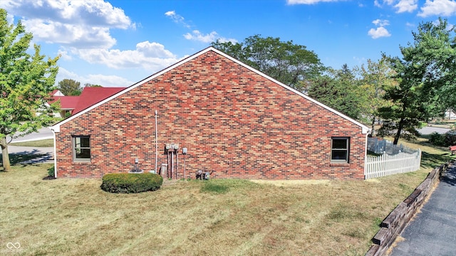 view of side of property with a yard