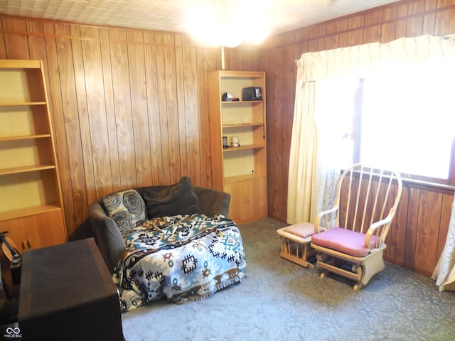 interior space featuring carpet floors and wooden walls