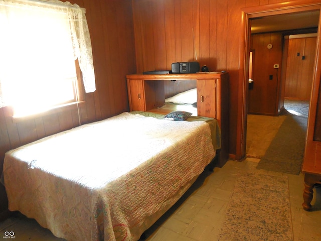 bedroom featuring wood walls