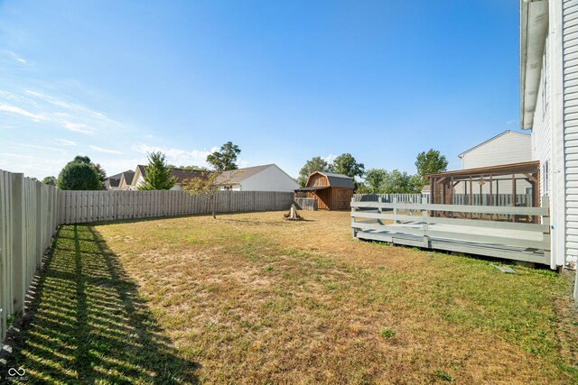 view of yard with a deck and a storage shed