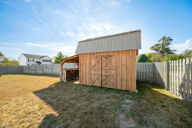 view of outbuilding with a lawn