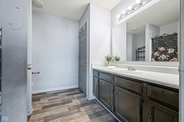 bathroom featuring vanity, a textured ceiling, and hardwood / wood-style flooring