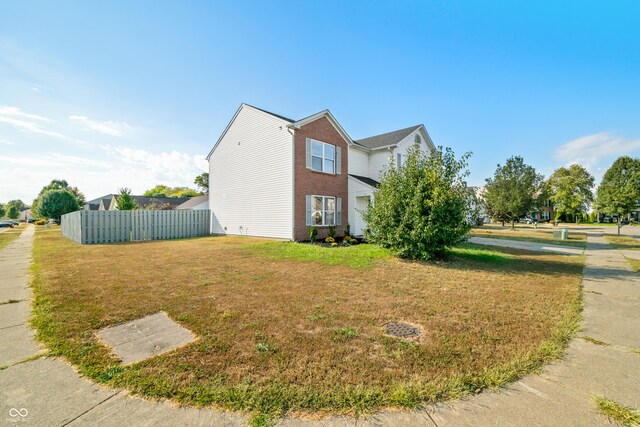 view of side of property with a lawn