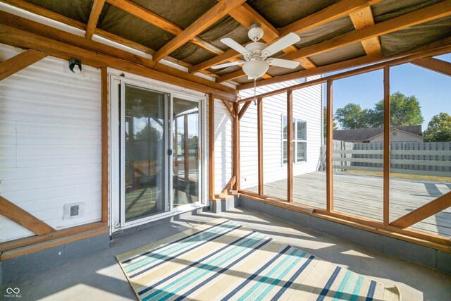 unfurnished sunroom with ceiling fan and a wealth of natural light