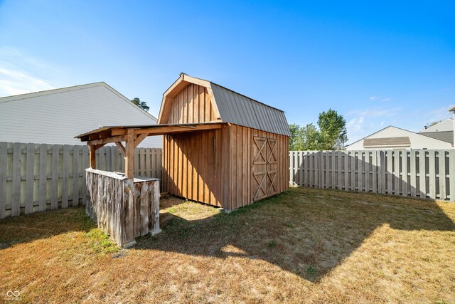 view of outbuilding with a lawn