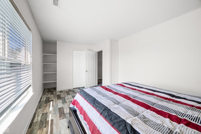 bedroom featuring dark hardwood / wood-style flooring