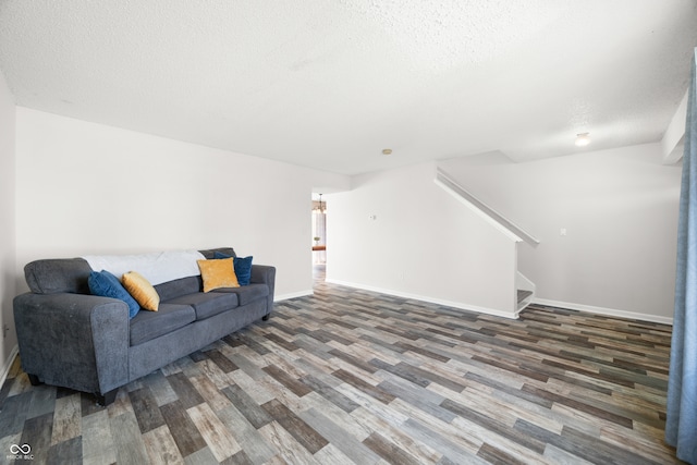 living room with wood-type flooring and a textured ceiling