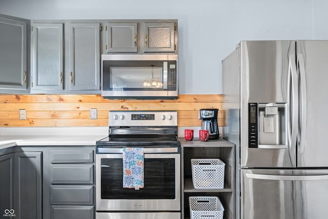 kitchen featuring appliances with stainless steel finishes and gray cabinets