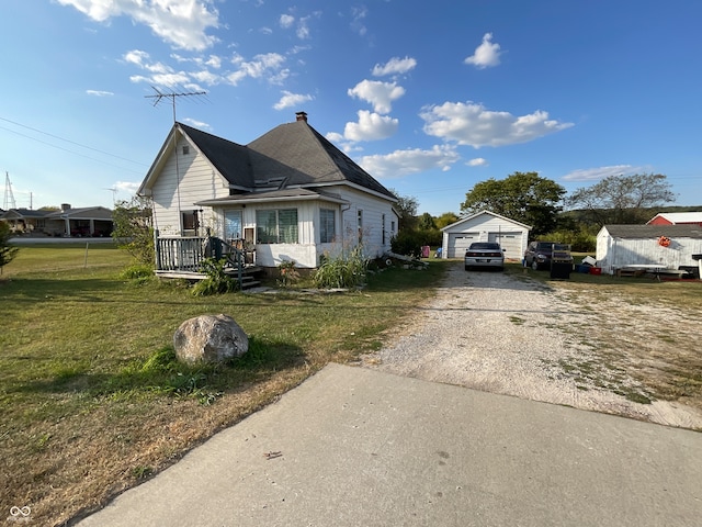 bungalow with a front lawn and a deck