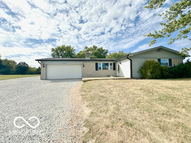 ranch-style home with a garage and a front lawn