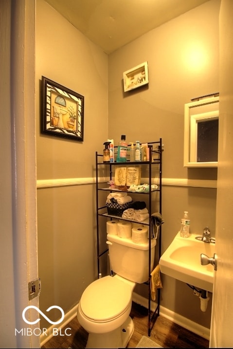 bathroom with sink, hardwood / wood-style flooring, and toilet