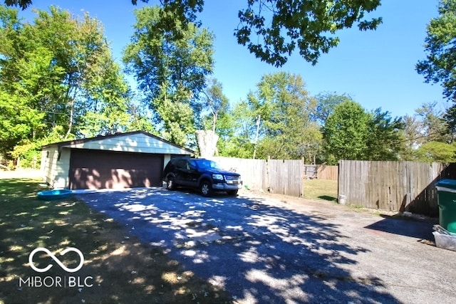 view of side of property featuring an outdoor structure and a garage