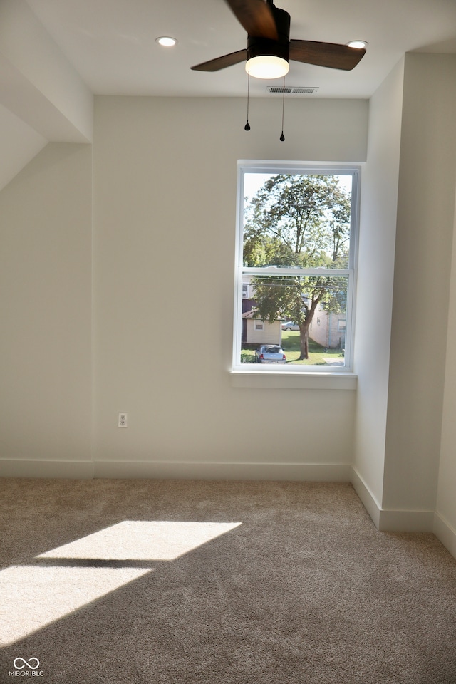 unfurnished room featuring carpet and ceiling fan