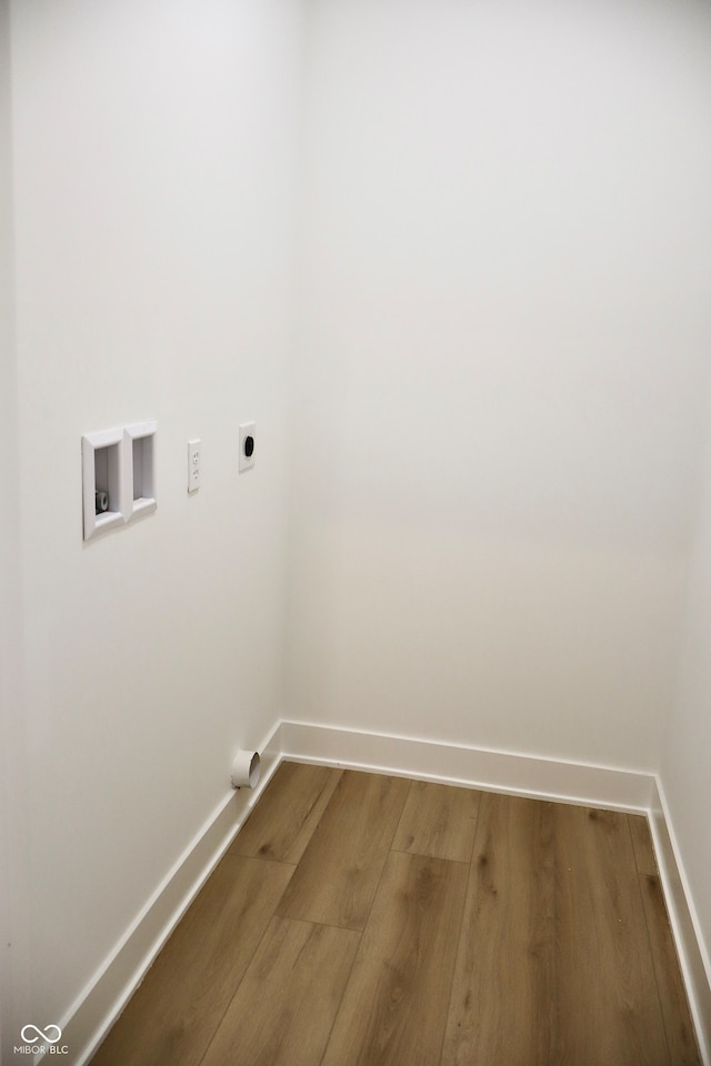 washroom with wood-type flooring, hookup for an electric dryer, and washer hookup