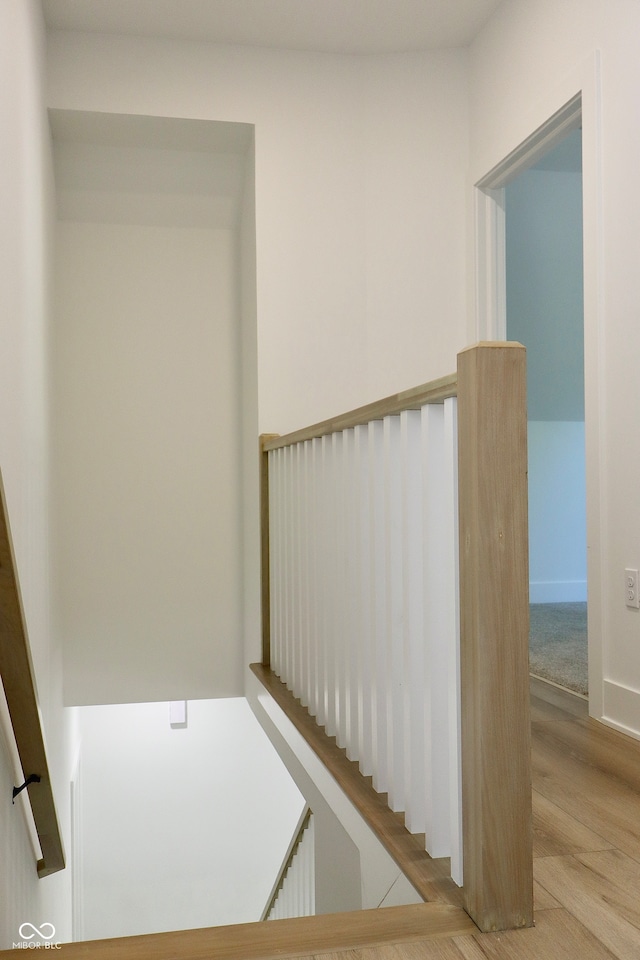 stairs featuring hardwood / wood-style flooring