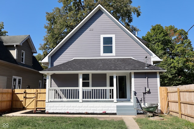 rear view of house featuring covered porch