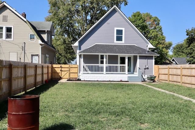 rear view of property with a lawn and covered porch