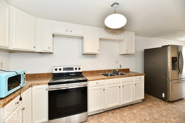 kitchen with white cabinetry, sink, decorative light fixtures, and appliances with stainless steel finishes