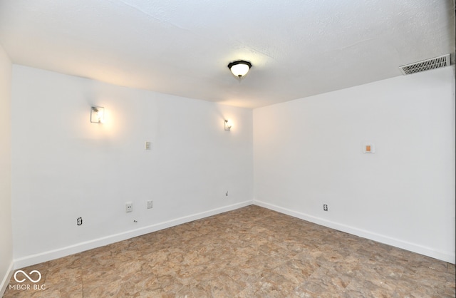 spare room featuring a textured ceiling