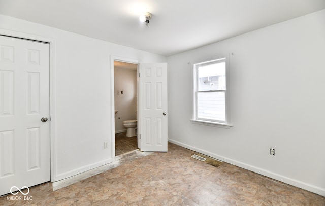 unfurnished bedroom featuring ensuite bathroom