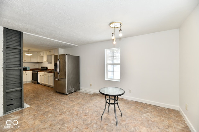 kitchen featuring a textured ceiling and appliances with stainless steel finishes