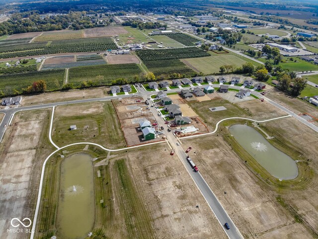 drone / aerial view featuring a water view and a rural view