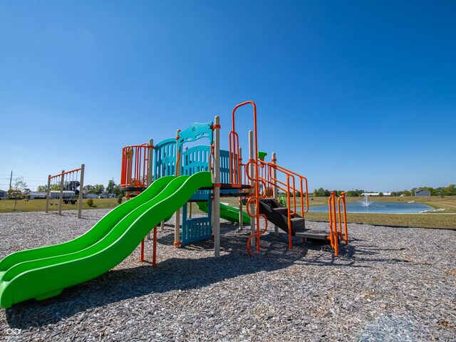 view of jungle gym with a water view