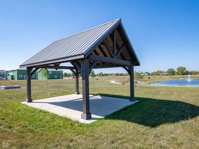 surrounding community featuring a gazebo, a water view, and a lawn