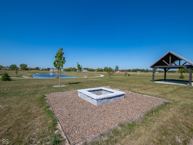 entry to storm shelter featuring a water view and a yard