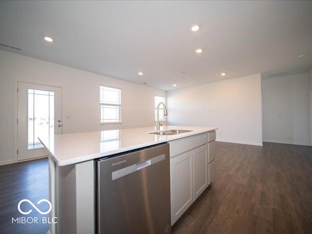 kitchen with dark hardwood / wood-style floors, white cabinetry, sink, a kitchen island with sink, and stainless steel dishwasher