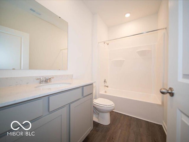 full bathroom with shower / tub combination, hardwood / wood-style floors, vanity, and toilet