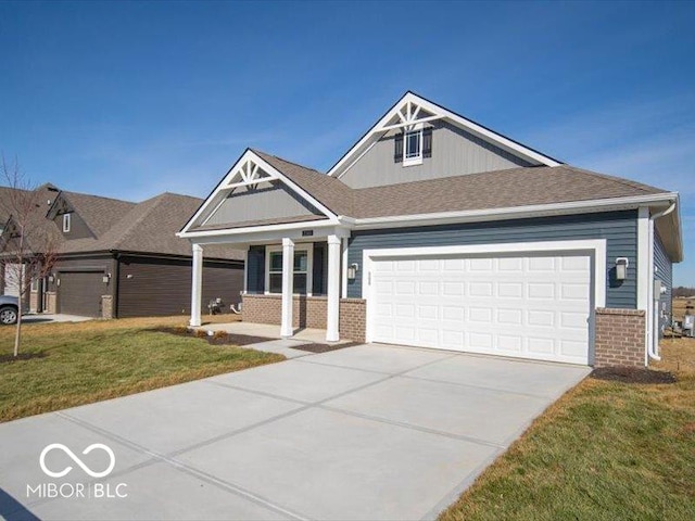 craftsman inspired home with a garage and a front lawn